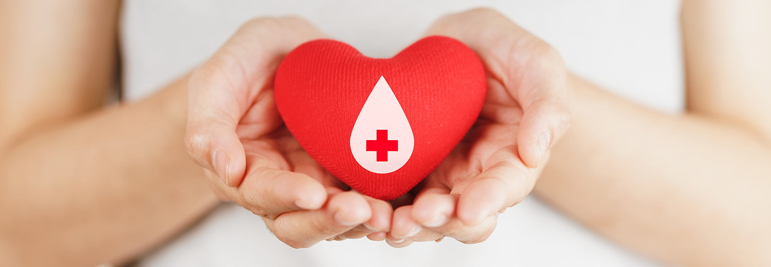 woman hands holding red heart with blood donor sign healthcare medicine and blood donation concept1500
